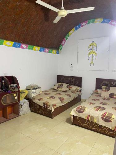 a room with two beds and a ceiling at منزل نوبي إضافة in Aswan