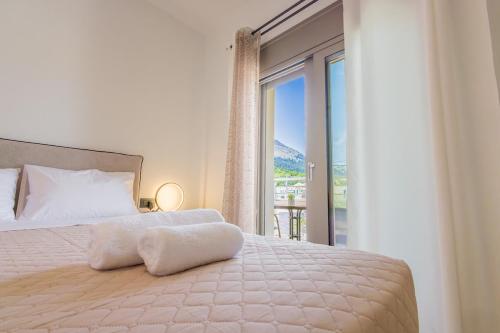 a bedroom with a bed with a large window at Marizaf house in Émbonas