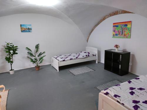 a room with two beds and a table at Ubytovanie Čadca in Čadca