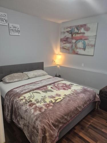 a bedroom with a bed with a blanket on it at Enjoy Life in Heart of North Delta in Delta