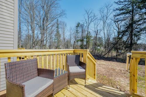a wooden deck with two chairs on it at Elegant 2Story Bloomfield 3 Kings 2 Queens in Bloomfield