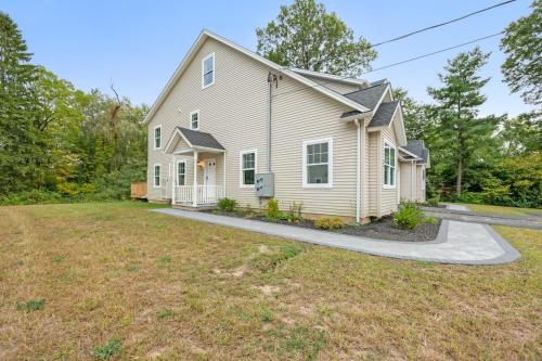 a white house with a yard at Elegant 2Story Bloomfield 3 Kings 2 Queens in Bloomfield