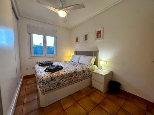 a small bedroom with a bed and a window at Villa Alegre - 2 bed villa with private heated pool on Mar Menor Golf - family friendly in Torre-Pacheco