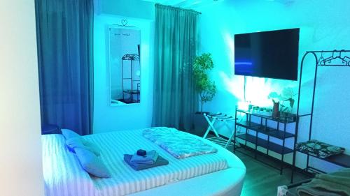 a blue bedroom with a bed and a desk at Il sogno di Elisa in Parma