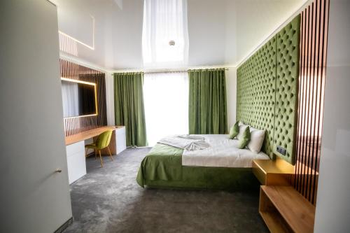 a bedroom with a bed with green curtains and a window at Fit Residence Hasdeu in Cluj-Napoca