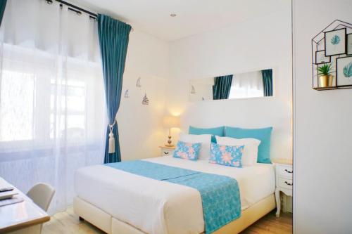 a bedroom with a bed with blue and white at Kasa 23 Cascais - Boutique Guest House in Cascais