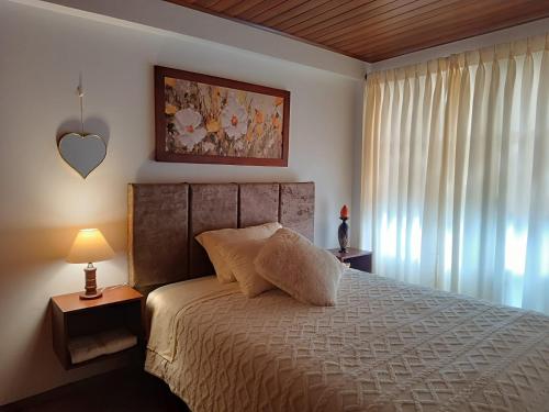 a bedroom with a bed with a white bedspread at INTI & QUILLA Appartments in Sibundoy