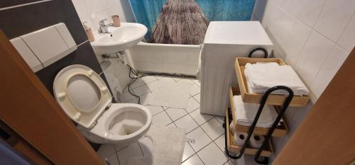 a small bathroom with a toilet and a sink at Cozy & Fully Equipped Flat in a Prime Location in Essen