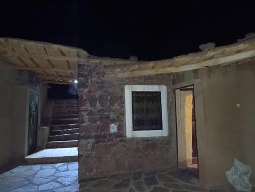 a building with a window on the side of it at Dar Agourzi Café des Epices in Tacheddirt