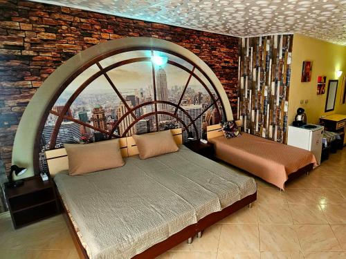 a bedroom with two beds and a large window at Курортно студио in Sunny Beach