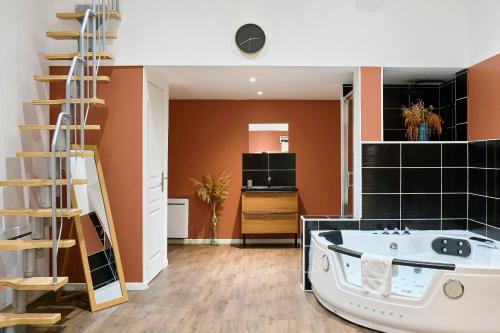 a bathroom with a tub in the middle of a room at NG Prestige - Nain - Suite Spa Privatif - Jacuzzi - Netflix - Projecteur in Roubaix