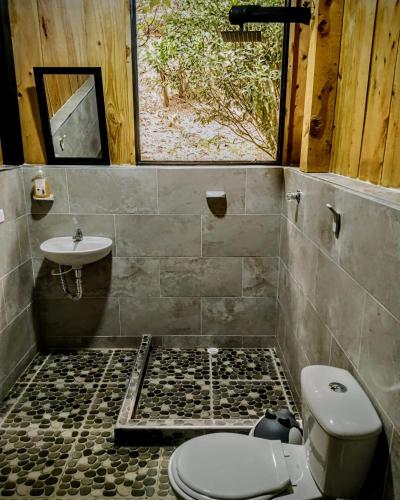 a bathroom with a toilet and a sink at Era Vella in Machetá