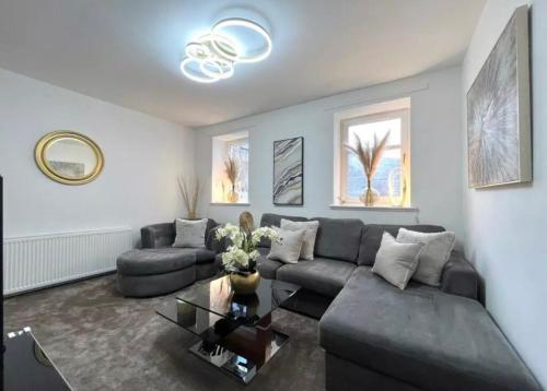 a living room with a couch and a table at Cosy Hideaway in Stirling