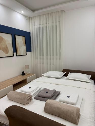 a bedroom with two beds with towels on them at Stan na dan Bogdan Ub in Ub