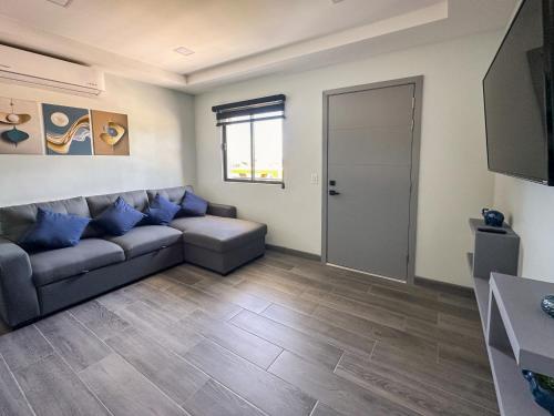a living room with a couch and a flat screen tv at Apt Four A #4 in Punta Penasco New