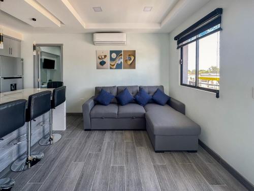 a living room with a couch and a kitchen at Apt Four A #4 in Punta Penasco New