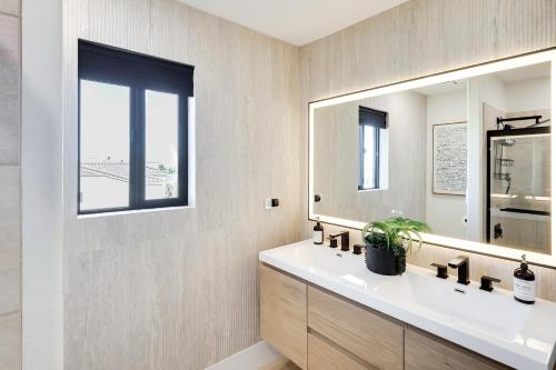 a bathroom with a sink and a mirror at 4 Mi to Dtwn Luxe Gem with Pool in Lake Havasu City in Lake Havasu City