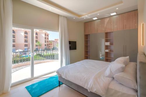a bedroom with a large bed and a large window at Selena Bay Beach Resort in Hurghada