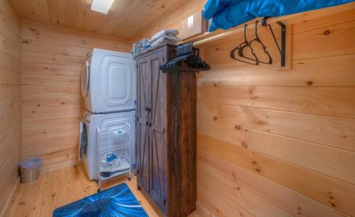 a room with a refrigerator in a wooden wall at The Fawn at Deer Ridge in Murphy