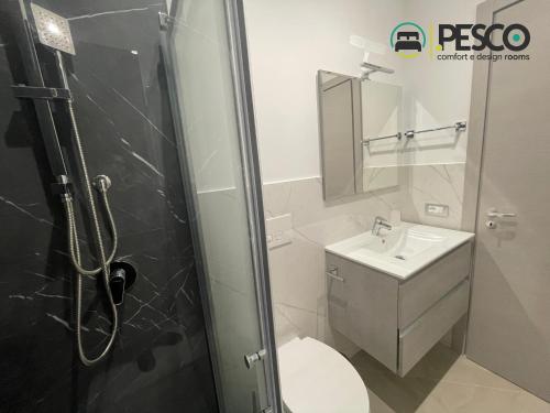 a bathroom with a shower and a toilet and a sink at Pesco Rooms Marineo in Marineo