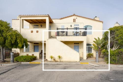 a large white house with a balcony at Sandbar Escape in Oceano