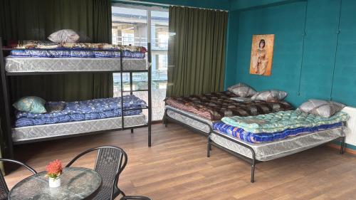 a room with three bunk beds and a table at Villa Palma in Tbilisi City