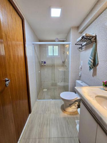 a bathroom with a shower and a toilet and a sink at Beach Place ACONCHEGO e refúgio perto do mar in Cumbuco