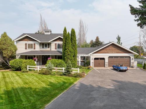 a house with a car parked in a driveway at Country Way Inn in Kalispell