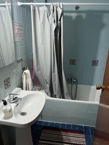 a bathroom with a sink and a shower and a tub at habitacion en silla in Silla