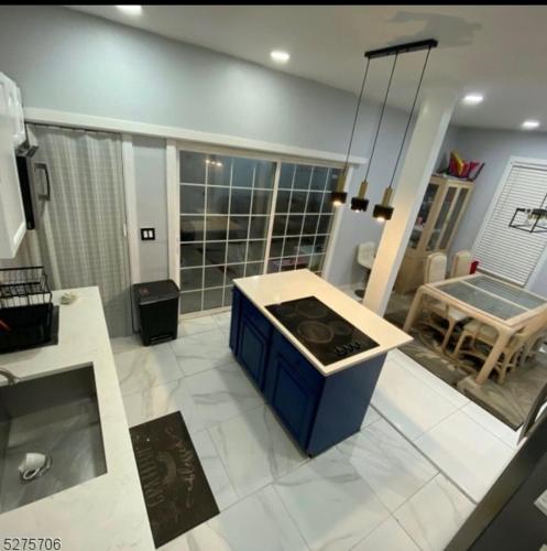 a kitchen with a stove in the middle of a room at private room in Paterson