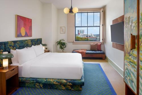 a bedroom with a white bed and a window at The Barnett JDV by Hyatt in New Orleans