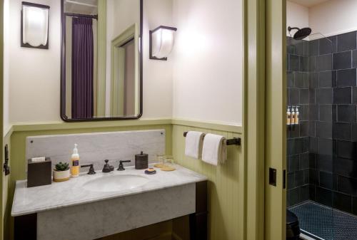 a bathroom with a sink and a mirror at The Barnett JDV by Hyatt in New Orleans