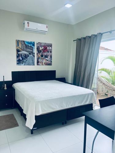 Un dormitorio con una cama grande y una ventana en MarisC&LHouse 1- Quarto casal, en Bombinhas