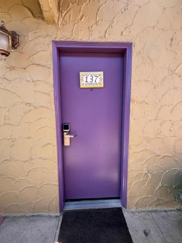 a purple door on the side of a building at Capitola Venetian Vacation Rentals in Capitola