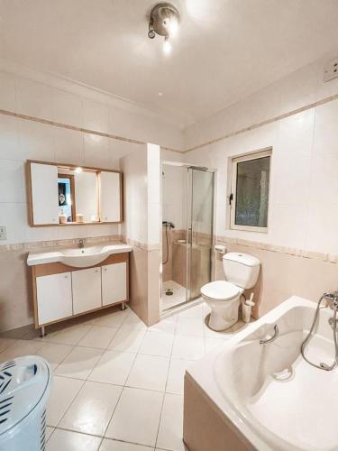 a bathroom with a tub and a toilet and a sink at Panoramic Sea Views 3 Bedroom Apartment in St Julians in St Julian's