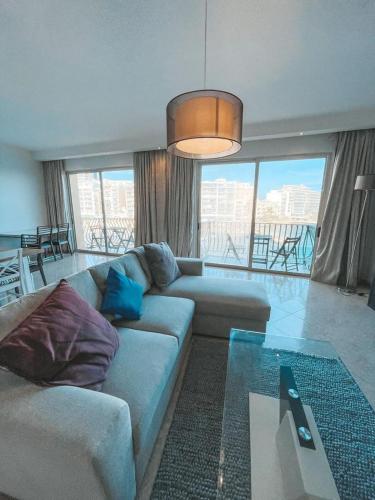 a living room with a couch and a table at Panoramic Sea Views 3 Bedroom Apartment in St Julians in St Julian's