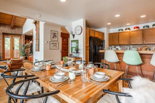 a kitchen and dining room with a wooden table and chairs at Cedar and Snow in Mammoth Lakes