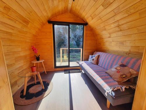 a living room with a couch and a window at Espacio Verde in Juan Chico