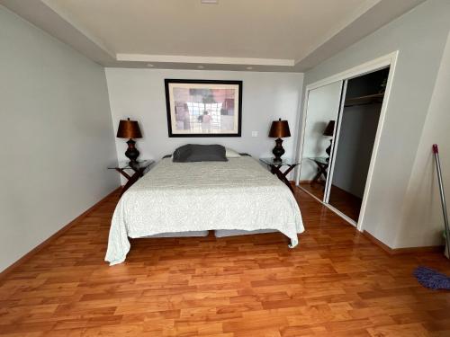 a bedroom with a bed and a wooden floor at Beach house oceacn front Rosarito in Rosarito