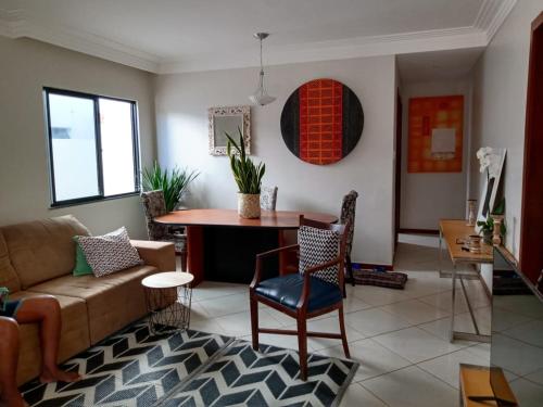 a living room with a couch and a table at Refúgio aconchegante in Salvador