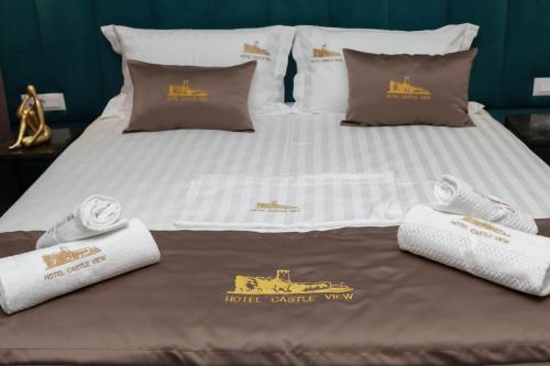 a bed with two pillows and a tractor on it at Hotel Castle View in Krujë