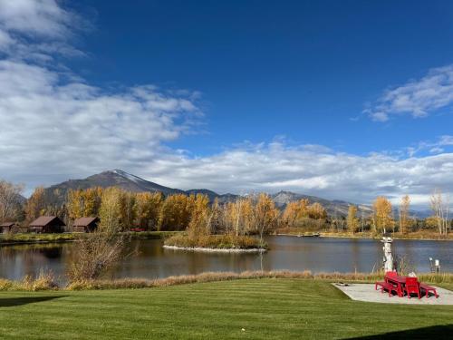 two red benches sitting in front of a lake at SkyWater Cabins in Hamilton