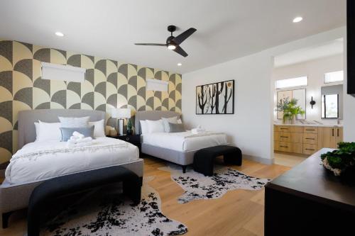 a bedroom with two beds and a ceiling fan at Sunrift-Private Pool & Spa-Walk to Old Town in Scottsdale