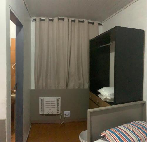 a bedroom with a mirror and a bed and a window at AP da val 3 no coração de Manaus in Manaus