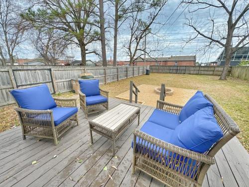 three chairs and a table on a wooden deck at Stylish 2BR in Decatur - Big Deck - Pets OK - Fire Pit in Decatur