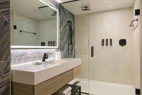 a bathroom with a sink and a shower at Renaissance Daytona Beach Oceanfront Hotel in Daytona Beach