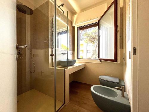 a bathroom with a shower and a sink and a toilet at Apartment in Rosolina Mare 54758 in Rosapineta