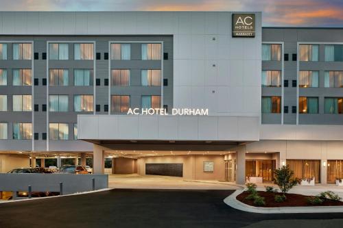 an as hotel durham building with a parking lot at AC Hotel by Marriott Durham Duke University in Durham