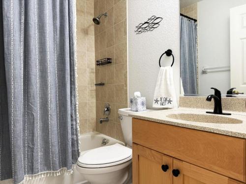 a bathroom with a toilet and a sink and a shower curtain at Pet-Friendly 3BR – Relax & Explore Beaches & Golf in Rotonda