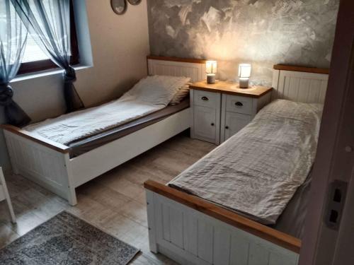 two twin beds in a room with a window at Holiday home in Balatonlelle 54843 in Balatonboglár Vasútállomás